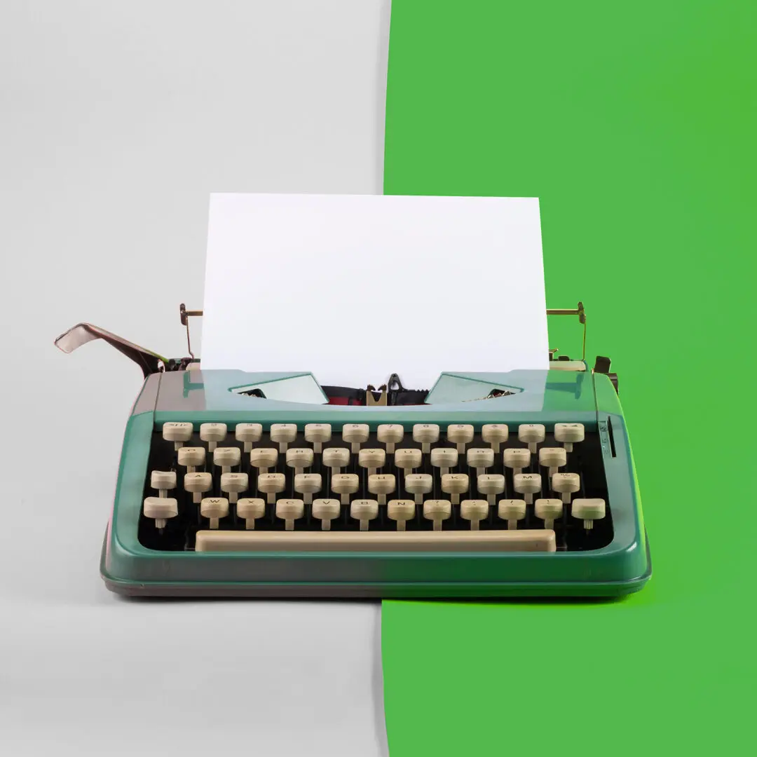 Final copy medical writers James and John uk Vintage typewriter with paper sheet on green and grey